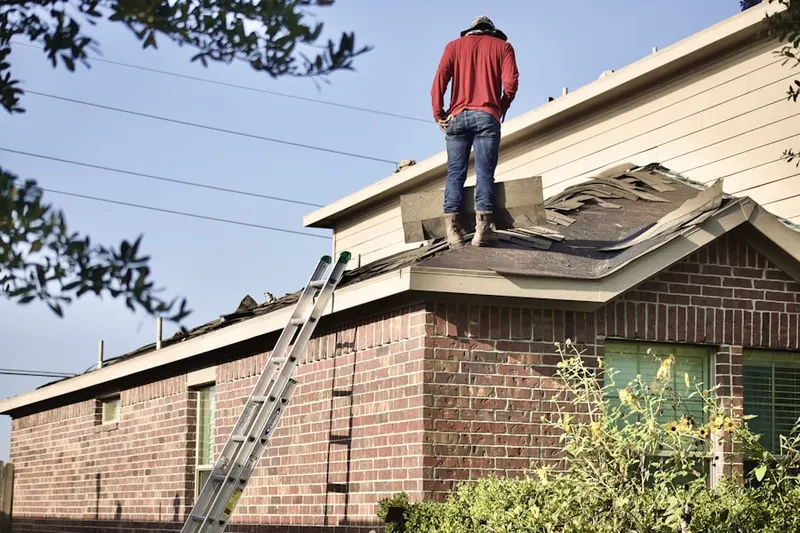 Professional roofer working on a residential roof in Morrison Farms